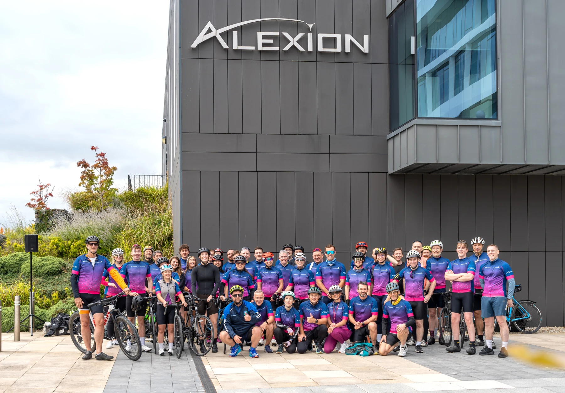 Alexion colleagues gathered with their bikes outside the Alexion building