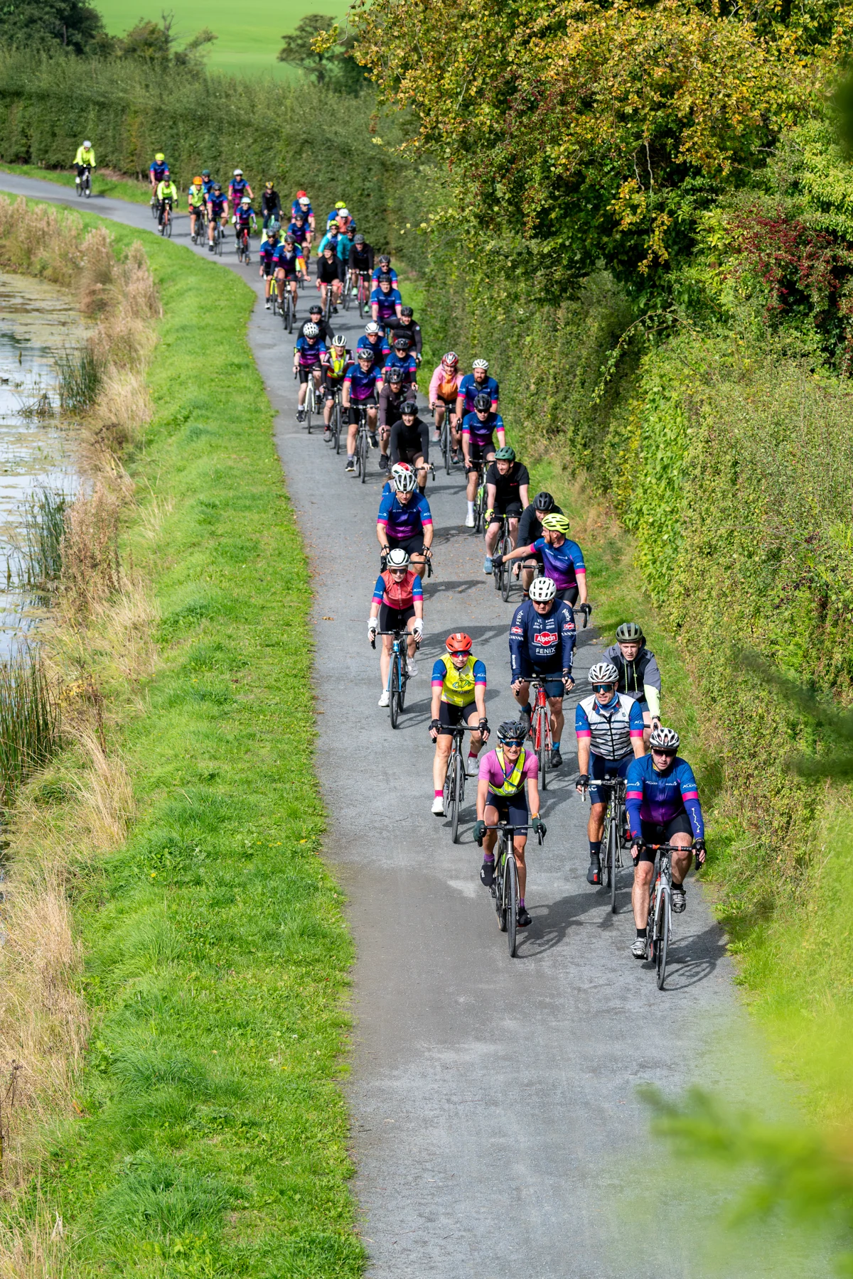 Colleagues enjoying a cycle beside the water