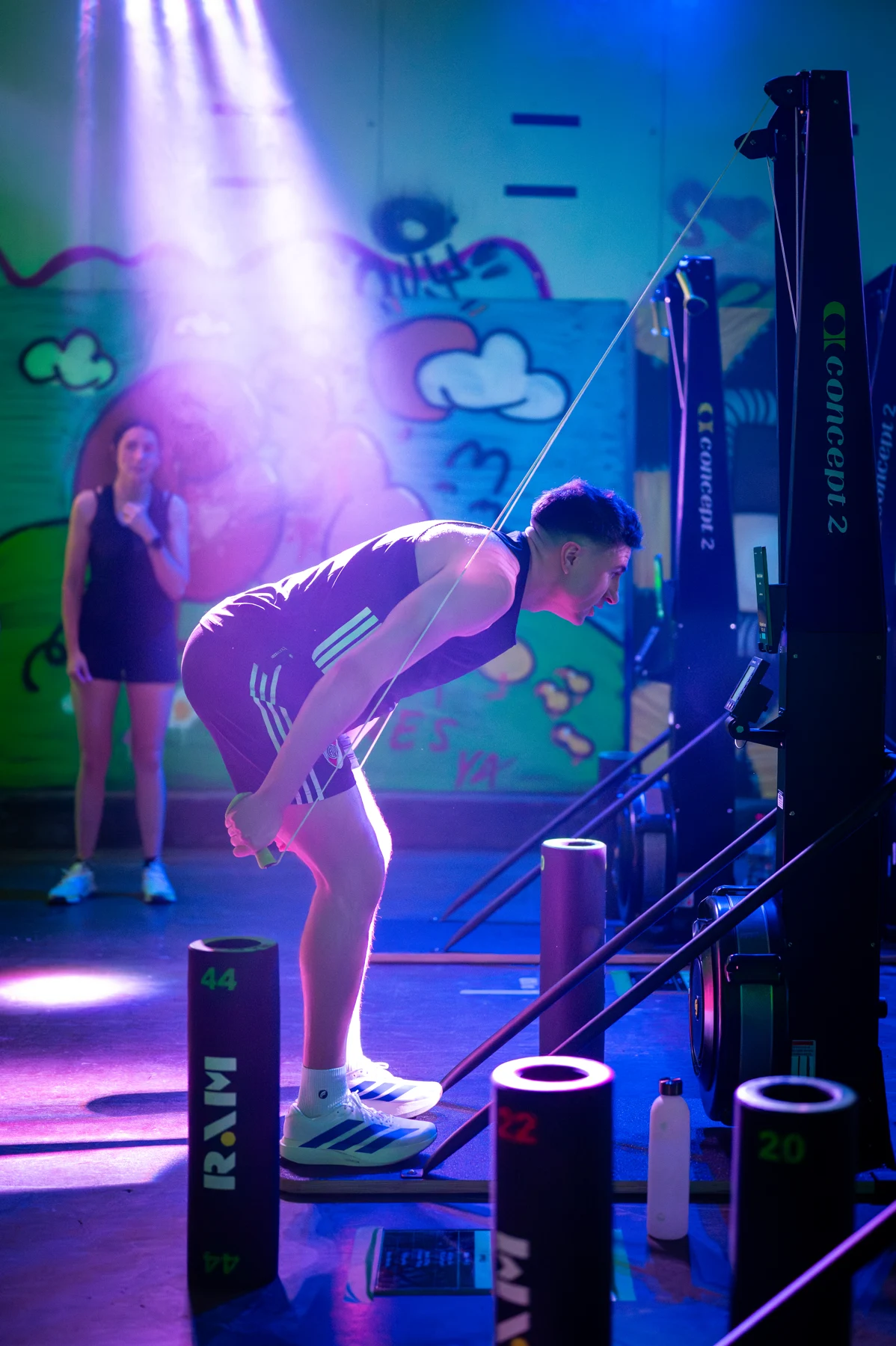 A participant using a SkiErg at an indoor fitness event