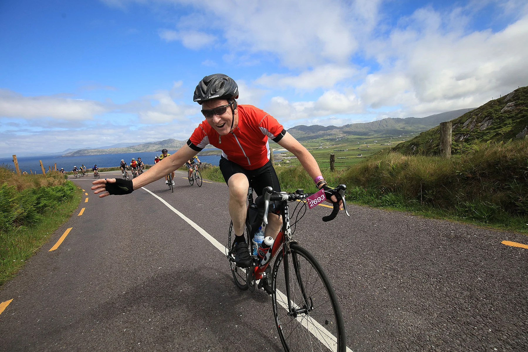 A smiling cyclist enjoying a scenic outdoor challenge